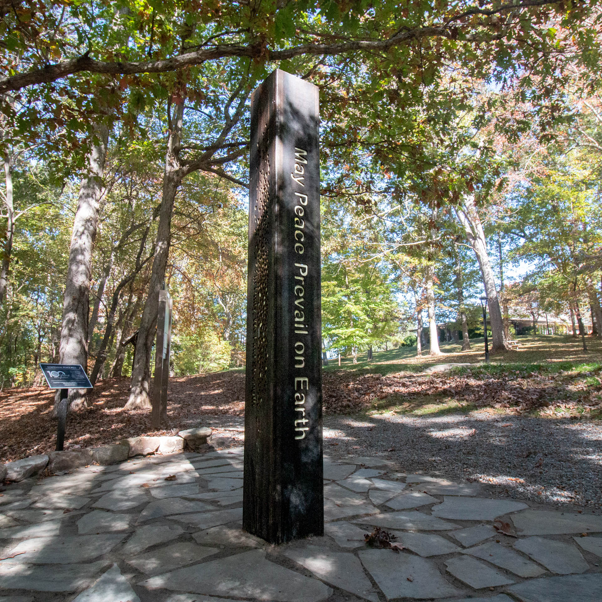 rectangular pole with May Peace Prevail on Earth cut out of the metal
